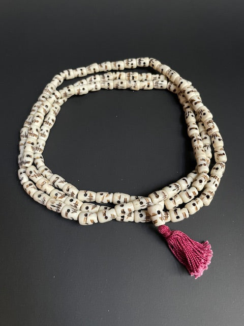 Very long yak bone necklace with skulls - white