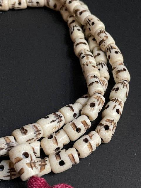 Very long yak bone necklace with skulls - white