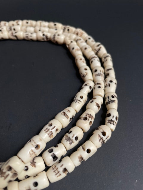 Very long yak bone necklace with skulls - white